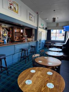 a restaurant with tables and chairs and a bar at The Blue Bell Inn in Amble