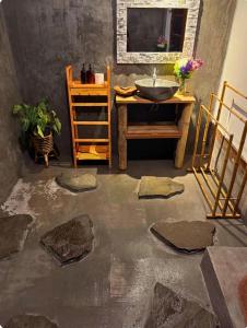 a room with a sink and a table with rocks at Umajro - Cabin in Karangasem