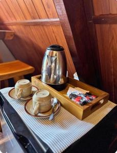 a tea kettle sitting on top of a table at Umajro - Cabin in Karangasem