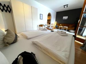 a bedroom with two beds and a living room at Seeuferresidenz am Adrian Stoop NEU eingerichtet in Bad Wiessee