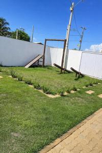a park with a bench and a swing at Espaço Villa Manguinhos in São Francisco de Itabapoana