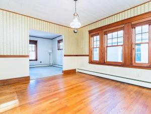 an empty room with wood floors and windows at spacious room with great amenities in Boston
