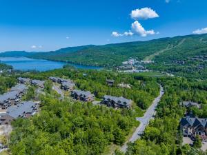 an aerial view of a town with a lake and houses at Tremblant Prestige - Verbier 4-102 in Mont-Tremblant