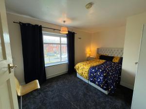 a bedroom with a bed and a window at Cozy Private Spacious Blackout Room in Longley