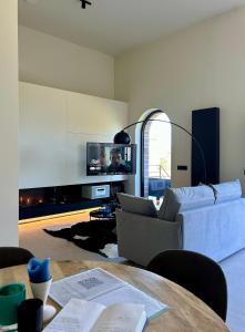 a living room with a couch and a table at Le Castel Mosan in Namur +91 photos