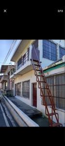 a building with a staircase on the side of it at Zacatecoluca House 2 in Zacatecoluca