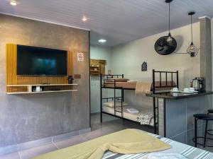 a room with a flat screen tv on a wall at Bella Mar Suítes in Angra dos Reis