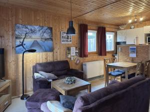 a living room with couches and a table and a kitchen at Ruhiger Aufenthalt in Gehren in Altenfeld
