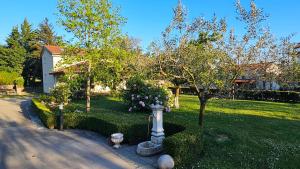 a garden with a fire hydrant in a yard at Apartments Kompara in Ajdovščina