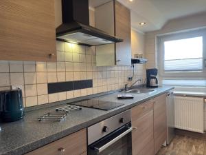 a kitchen with a sink and a counter top at Peaceful Forest Getaway in Altenfeld