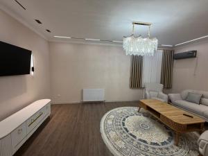 a living room with a couch and a table at Shayxul Islam 5 in Bukhara