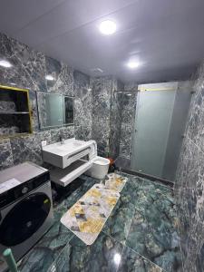 a bathroom with a sink and a toilet and a shower at Shayxul Islam 5 in Bukhara