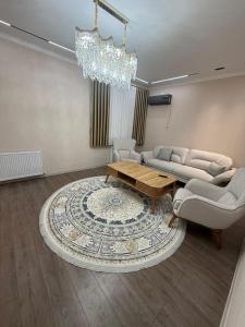 a living room with a couch and a coffee table at Shayxul Islam 5 in Bukhara