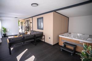 a large bathroom with a tub and a couch at AC Ivona - Mobile home AURORA Vodice in Vodice
