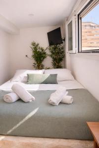 a bedroom with two beds and a tv on the wall at Olive tree studio ,Corfu Town in Ágios Rókkos +18 photos