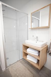 a bathroom with a sink and a shower at AC Ivona - Mobile home AURORA Vodice in Vodice +17 photos