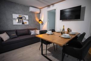a living room with a table and a couch at AC Ivona - Mobile home AURORA Vodice in Vodice