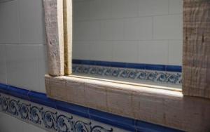a window in a bathroom with blue and white tiles at Ocean front surf House El Cotillo in El Cotillo +21 photos