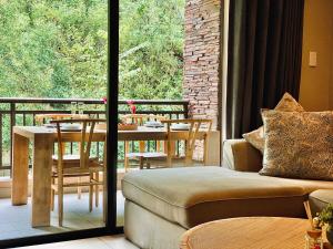 a living room with a couch and a table on a balcony at 320 Zimbali Suites in Ballito