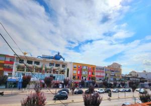 a city with cars parked in a parking lot at Apartament me qira ditore "AGA"Fier in Fier