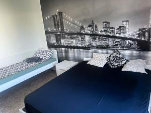 a bedroom with a large blue bed and a city skyline at Appartamento Treviglio-centro in Treviglio