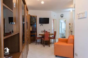 a living room with a table and a dining room at Otranto City Center - Steps from the Beach in Otranto