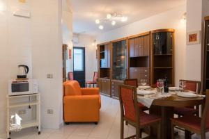 a kitchen and dining room with a table and chairs at Otranto City Center - Steps from the Beach in Otranto