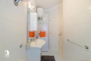a white bathroom with a sink and a mirror at Otranto City Center - Steps from the Beach in Otranto +45 photos