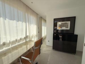 a living room with a large window and a television at ALGAIDAMAR BEACH LUXURy in Sitio de Calahonda