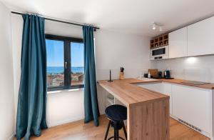a kitchen with a table and a large window at Villa Senzen in Baška Voda