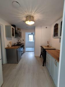 a kitchen with blue cabinets and a ceiling at Ranczo in Smołdzięcino +19 photos