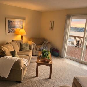 a living room with a couch and a table at Markley Manor - Beautiful views in Sunrise Beach