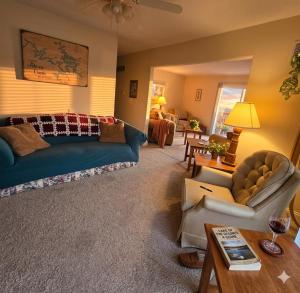 a living room with a couch and a table at Markley Manor - Beautiful views in Sunrise Beach