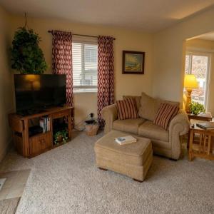 a living room with a couch and a television at Markley Manor - Beautiful views in Sunrise Beach