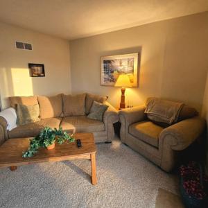 a living room with two couches and a coffee table at Markley Manor - Beautiful views in Sunrise Beach +11 photos
