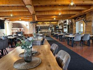 a dining room with tables and chairs in a restaurant at Slanický Dvor in Námestovo