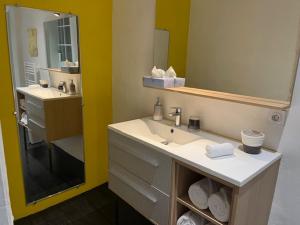a bathroom with a sink and a mirror at In Situ B&B in Uzès