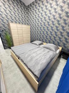 a large bed in a room with a wall at Teplice Apartments 1 in Teplice