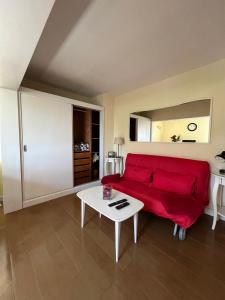 a living room with a red couch and a table at Beach House Largo da Agrela in Viana do Castelo