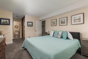 a bedroom with a bed with a blue comforter at Cavalier Condos #32 in Lincoln City +26 photos