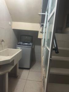 a bathroom with a sink and a washing machine at Domi ApartHotel , first floor and duplex in Cusco