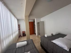 a bedroom with a bed and a couch at Domi ApartHotel , first floor and duplex in Cusco