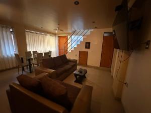 a living room with a couch and a table at Domi ApartHotel , first floor and duplex in Cusco