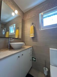 a bathroom with a sink and a mirror at Beach House Largo da Agrela in Viana do Castelo +12 photos
