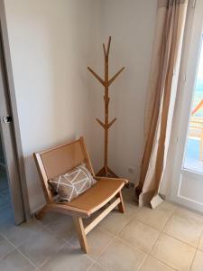a chair with a pillow in a room with a cross at Casa Punta Di Vista in Venaco