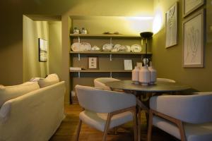 a dining room with a table and chairs at Espaço Calheta in Ponta Delgada