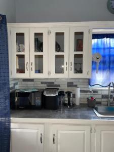 a kitchen with white cabinets and a sink at Serene Escape in Bellevue