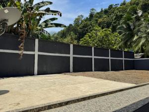 a concrete sidewalk next to a black fence at Los Cabos in Bahía Solano +16 photos