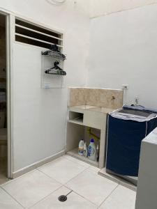 a kitchen with a door and a shelf with a bird at Apto Albor Blanco in Popayan