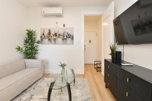 a living room with a couch and a glass table at Chic 2BR Stay-Steps From Central Park in New York